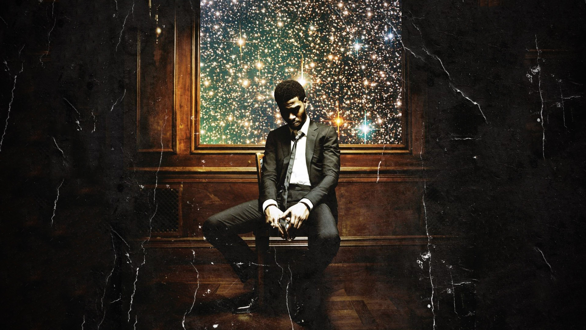 Kid cudi sitting in a Chair