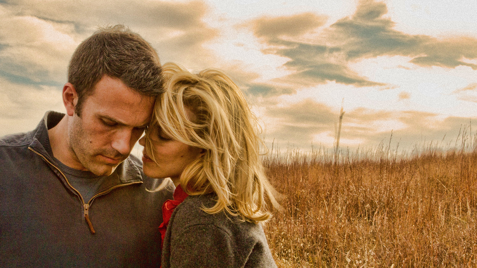 Ben Affleck and Rachel McAdams in a wheat field.